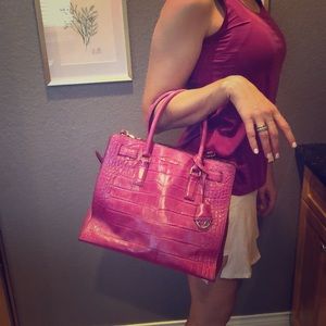 Michael Kors Pink handbag with strap.